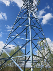 geometric design of a power line tower against a blue sky background