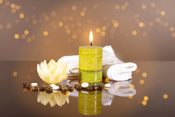 Scented candles and massage stones as a concept of meditation, relaxation, spa, peace and inner self