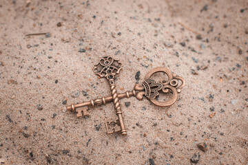 Two old keys on the sand. Lost vintage keys.