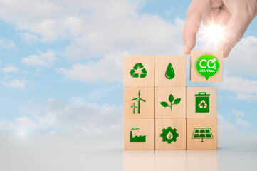 Net zero and carbon neutral concept. Put wooden cubes with green net zero icon. Hand put wooden...
