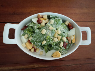 Caesar vegetable salad with parmesan cheese lettuce egg bread