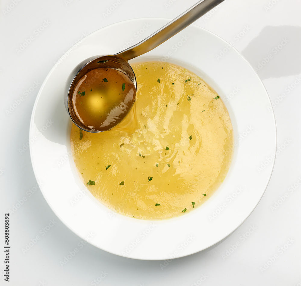 Wall mural chicken broth pouring into soup plate