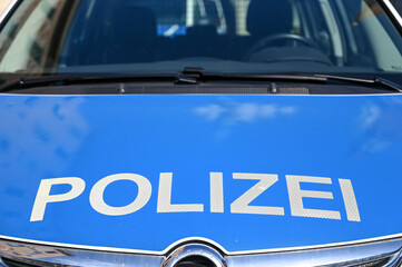 German police cars on the street. Side view of a police car with the lettering "Polizei".  Police patrol car parked on the street in Germany.