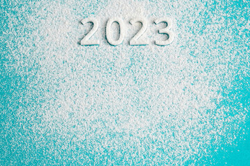 2023 white numbers and snow on blue background, copy space. New year concept.