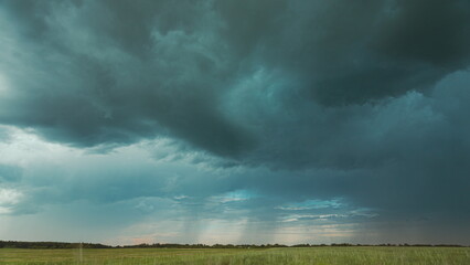 4K Sky During Rain Horizon Above Rural Wheat Landscape Field. Agricultural And Weather Forecast Concept. Storm, Thunder, thunderstorm, stormclouds, , , . Countryside Meadow In Summer Rainy Day