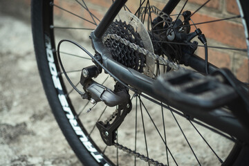 Fototapeta premium Close up of bicycle rear derailleurs. Sprocket cassette with chain, shifter and disk brake. Bike repair and maintenance work. preparing the bike for the season