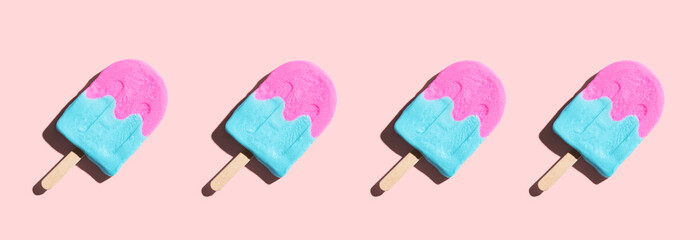 Pink and blue popsicles with shadow - flat lay