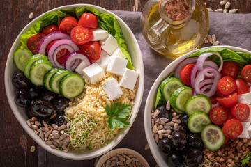 Fresh Greek salad with groats, feta cheese and vegetables.