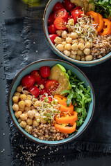 Healthy salad with groats, chickpeas, arugula and vegetables.
