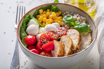 Fresh Caesar salad with groats, chicken and tomatoes.