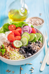 Healthy Greek salad with vegetables, cheese and buckwheat groats.
