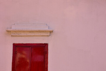 Classic red wooden window with white background.	