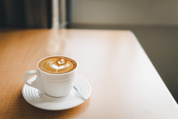 cup of latte art coffee on a table