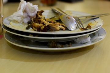 Dirty plate after eat Nasi Padang. Messy and there are some bones.
