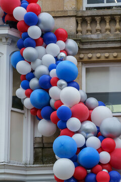 An abundance of inflated red,blue and white balloons displayed on side of a building to celebrate The Queen's Platinum Jubilee. 