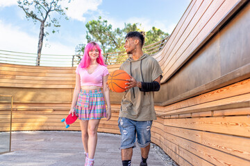 alternative diverse couple hanging out together chilling and smiling walking in the city. happy...