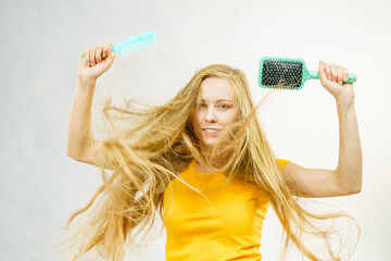 Girl blowing hair with comb brush