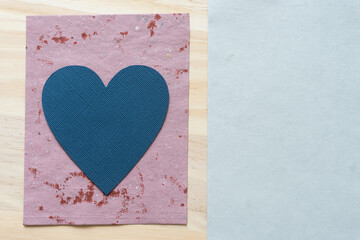 blue heart on paper and wood