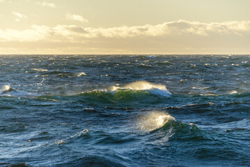 Beautiful seascape - waves and sky with clouds with beautiful lighting. Golden hour.
