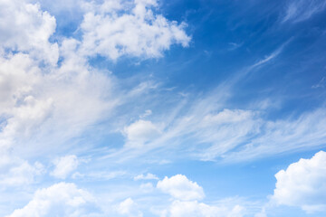 Naklejka na ściany i meble Soft and fluffy clouds formation on the bright sunny blue sky. Nature abstract background. Fresh air, weather and freedom concept