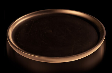 Podium black round tray illuminated in yellow with highlighted circle and reflect on black background for product presentation.