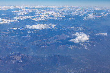 Mountain range view from above . Aerial view of peaks covered by snow 