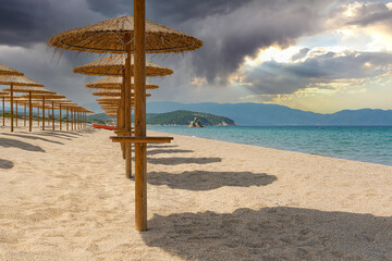 beach with umbrellas before rain or storm in bright colors