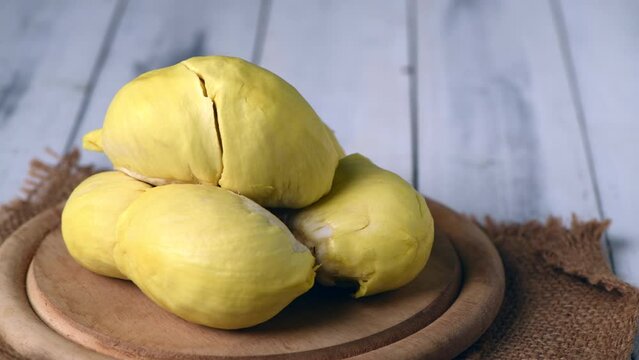 Pan motion of Fresh durian (monthong) on wood plate and white wood background, king of fruit from Thailand on summer season