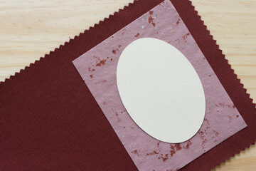 paper oval and stained paper on fabric and wood