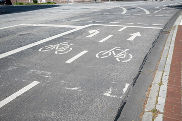 Signs printed on the road allowing cycling and arrows indicating the direction of movement. Security concept.