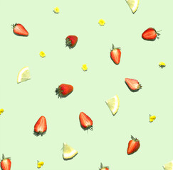 Fruit and flowers, creative pattern against pastel green background.