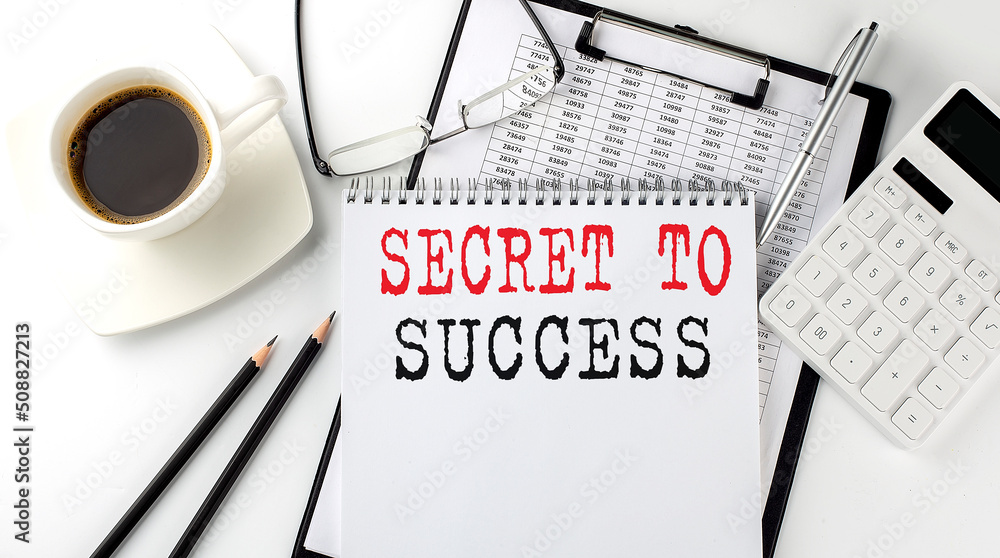Poster secret to success text on the paper with calculator, notepad, coffee ,pen with graph