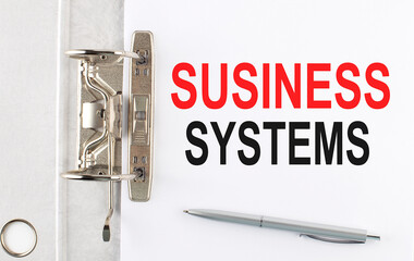 BUSINESS SYSTEM text on the paper folder with pen. Business concept