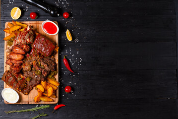 cold cuts with fried potatoes on a dark background