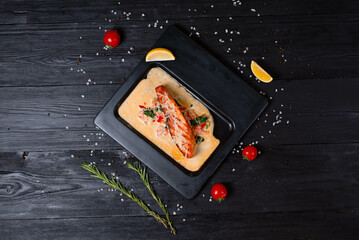 grilled salmon fish, with sauce and sprinkled with cheese