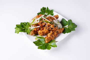 fried chicken wings, meat with herbs. on a white background