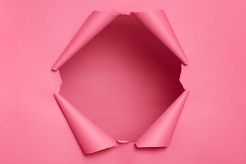 Big paper hole in center of pink background, blank space to insert your advertising content...