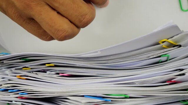 Slow motion close-up of businessman's hand searching for documents-4k footage