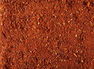 Spicy chili pepper flakes, crushed, milled dry red paprika pile texture, top view
