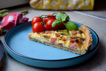 Quiche Lorraine Tart. Quiche is a tart consisting of pastry crust filled with eggs custard and pieces of cheese, bacon, and asparagus.