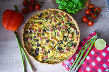 Quiche Lorraine Tart. Quiche is a tart consisting of pastry crust filled with eggs custard and pieces of cheese, bacon, and asparagus.