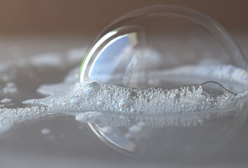 a beautiful soap bubble around the soap foam. beautiful background - obrazy, fototapety, plakaty
