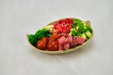 Poke bowl with shrimps, avocado and mango. Isolated on white background.