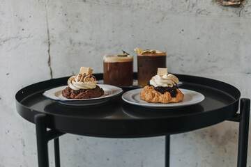 Dessert set of scones and americano coffee for couple served in cafe.