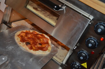 Margherita Pizza cooking in an electric  pizza oven, Italian recipe