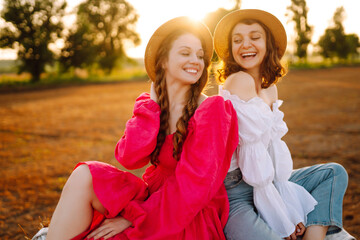 Two young women having fun  near haystack. Fashion concept. Nature, vacation, relax and lifestyle. Beautiful figures. Super mood. Summer concept.