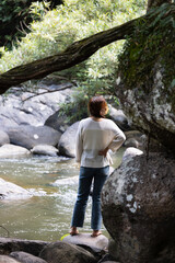 People are in the forest watching waterfalls and watching the beautiful nature playing in the water and relaxing on vacation. At Khao Yai National Park, Thailand, 16-05-2022