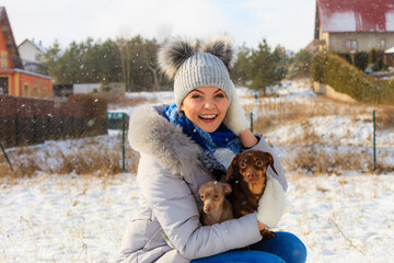 Woman playing with dogs during winter