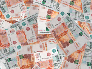 Russian money banknotes background consisting of one and five thousand Russian rubles banknotes