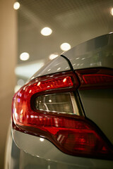 taillights of a sports car in gray. Close-up photo of car headlights. car lights on bokeh background © Vladibulgakov